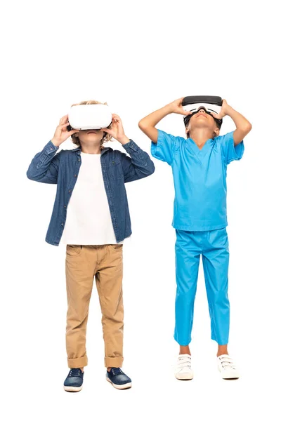 Kids touching virtual reality headsets isolated on white — Stock Photo