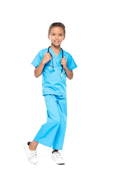 Child in costume of doctor touching stethoscope isolated on white — Stock Photo