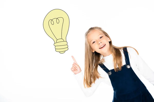 Blonde schoolgirl pointing at illustrated light bulb isolated on white — Stock Photo