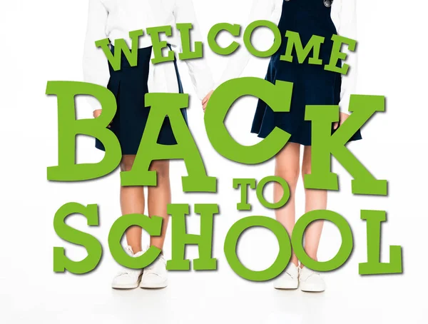 Cropped view of multicultural schoolgirls holding hands on white background, welcome back to school illustration — Stock Photo