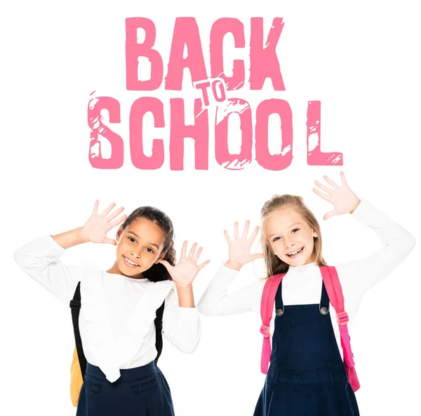 Multicultural schoolgirls showing chalk stained hands isolated on white isolated on white, back to school illustration — Stock Photo