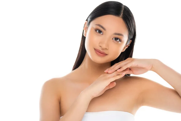 Young asian woman looking at camera and touching her hands isolated on white — Stock Photo