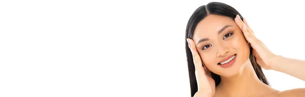 Panoramic shot of young asian woman touching face isolated on white — Stock Photo