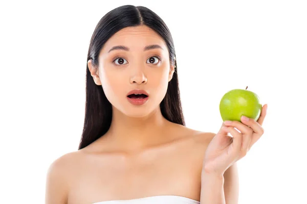 Surprised young asian woman looking at camera and holding apple isolated on white — Stock Photo