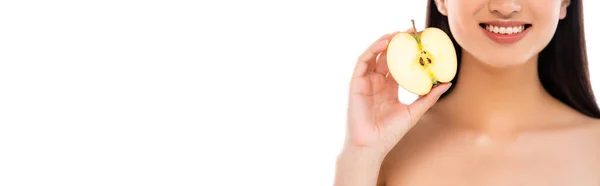 Panoramic partial shot of excited young  woman holding half of apple isolated on white — Stock Photo