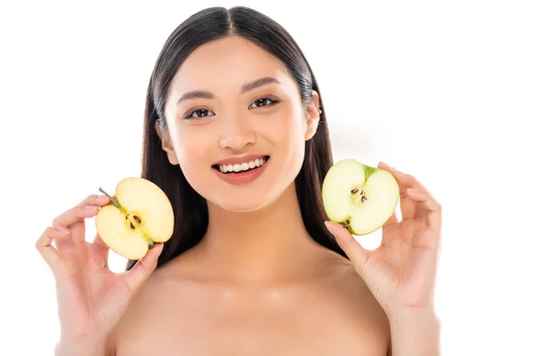 Naked asian woman holding cut apple while looking at camera isolated on white — Stock Photo