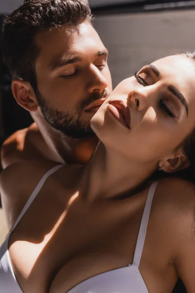 Selective focus of young sexy woman near shirtless man — Stock Photo