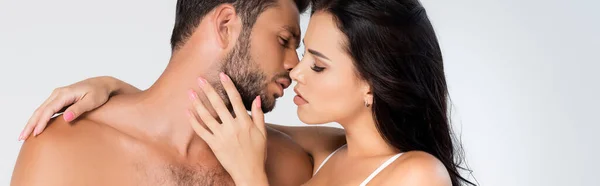 Panoramic crop of sexy woman touching face of shirtless man isolated on grey — Stock Photo
