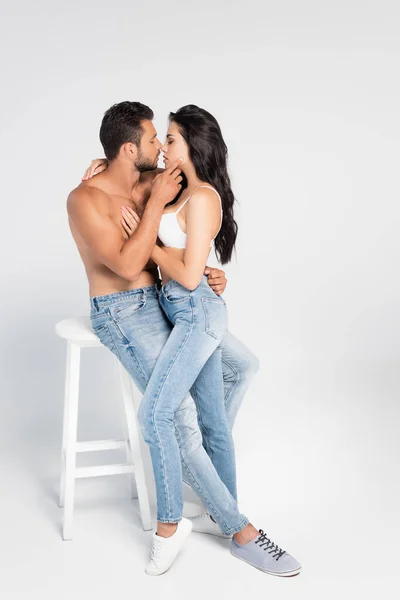 Side view of sexy couple with closed eyes hugging on grey — Stock Photo