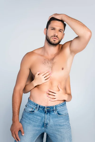 Woman touching torso of sexy and shirtless man isolated on grey — Stock Photo
