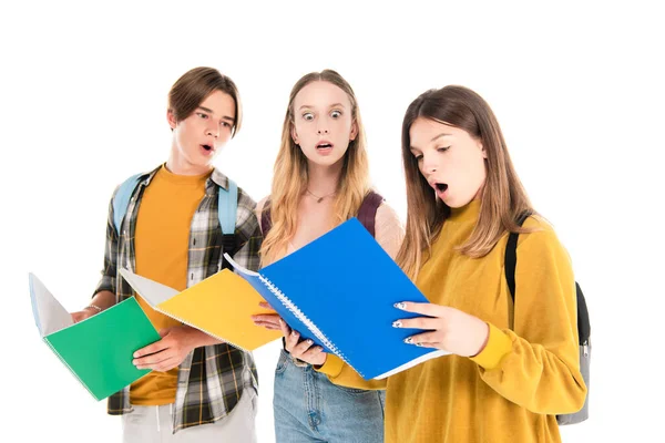 Shocked teenagers looking at notebook isolated on white — Stock Photo