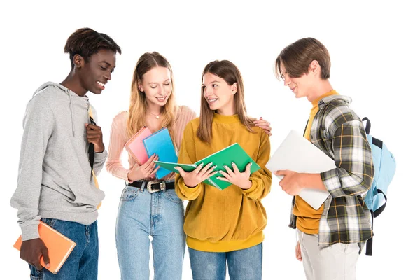 Adolescentes multiculturais sorridentes com laptop, livros e mochilas isoladas em branco — Fotografia de Stock