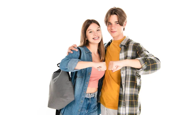 Positive teenagers hugging and doing fists bump isolated on white — Stock Photo
