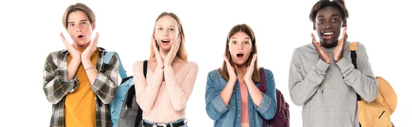Panoramic crop of excited multicultural teenagers looking at camera isolated on white — Stock Photo