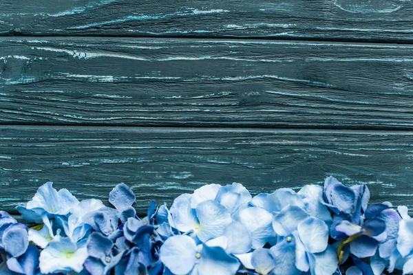 Vista superior de fondo verde madera con borde floral azul - foto de stock