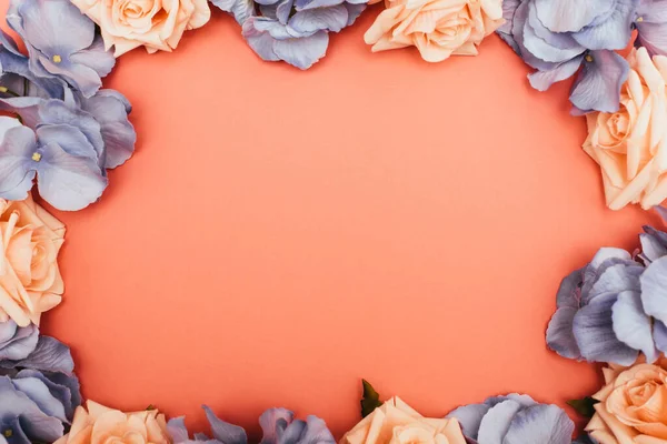 Top view of floral frame on coral background — Stock Photo