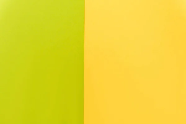 Вид сверху на красочный абстрактный желтый и зеленый бумажный фон — стоковое фото