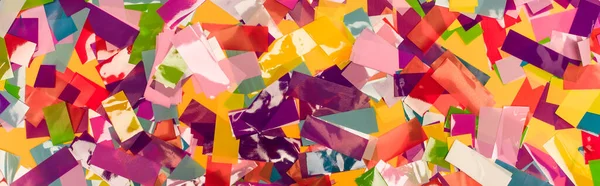 Top view of colorful bright confetti background, panoramic shot — Stock Photo