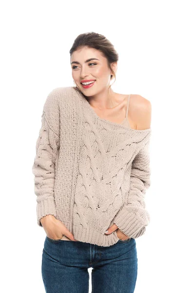 Coquettish woman in openwork sweater posing with hands in pockets isolated on white — Stock Photo
