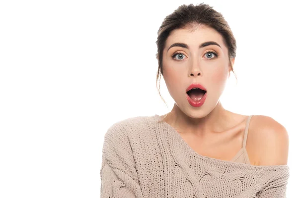 Shocked woman in trendy sweater looking at camera with open mouth isolated on white — Stock Photo