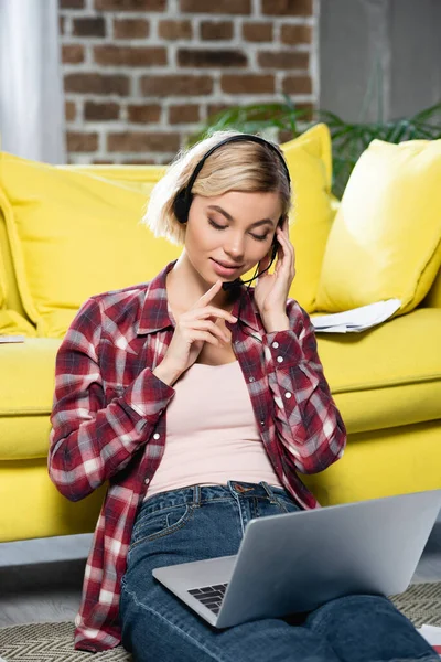 Young blonde woman having webinar and checking microphone — Stock Photo