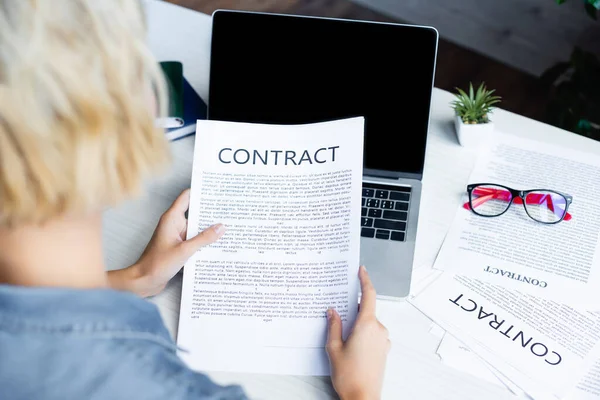 Back view of woman looking at contract — Stock Photo