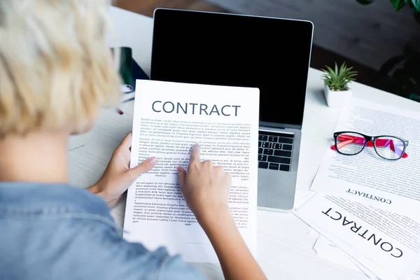 Back view of woman pointing with finger at contract — Stock Photo