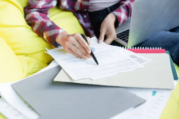 Cropped view of woman with pen reading document — Stock Photo