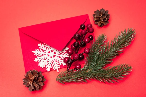 Vue de dessus de la décoration de Noël et enveloppe sur fond rouge — Photo de stock