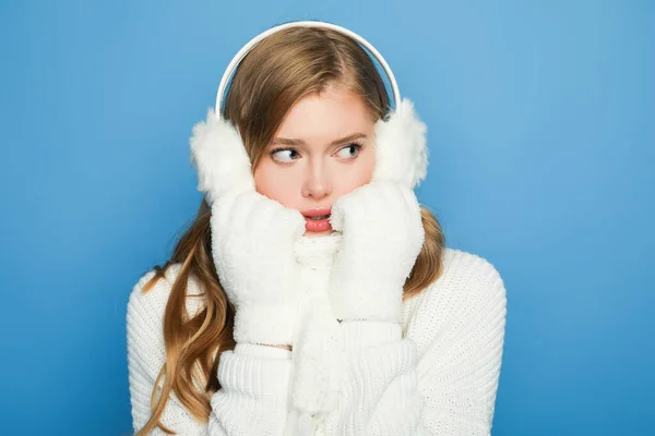 Beautiful woman in winter white outfit isolated on blue — Stock Photo