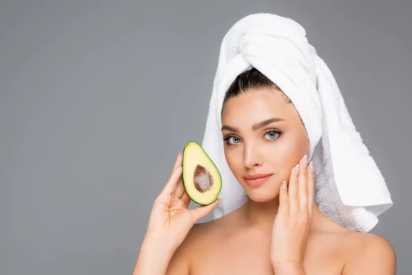 Donna con asciugamano sulla testa e avocado isolato su grigio — Foto stock