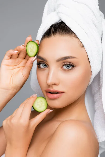 Woman with towel on head and cucumber isolated on grey — Stock Photo
