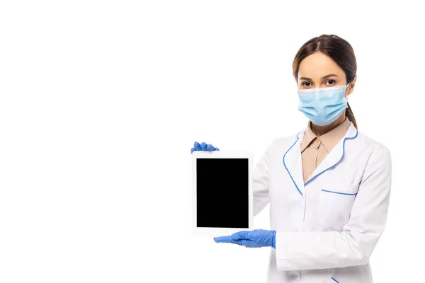 Doctor in medical mask and latex gloves holding digital tablet with blank screen isolated on white — Stock Photo