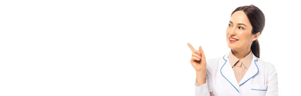 Horizontal crop of cheerful doctor pointing with finger isolated on white — Stock Photo