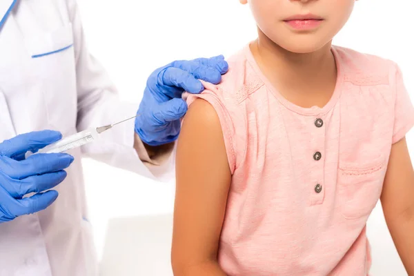 Cropped view of doctor in latex gloves holding syringe near child isolated on white — Stock Photo