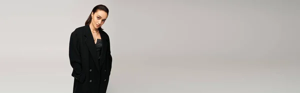 Brunette model elegantly poses in a trendy black outfit, radiating confidence and style, banner — Stock Photo