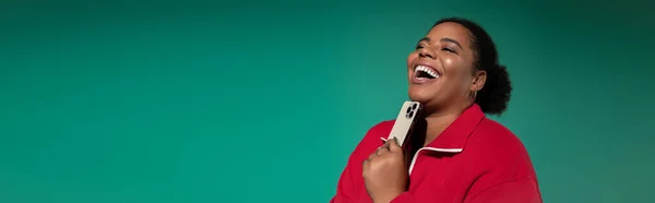 Афроамериканка plus size демонстрирует свой триумфальный осенний наряд, восхитительно улыбаясь. — стоковое фото