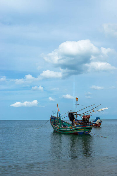 Minimal of Fishing boat on the sea with sky and cloud.