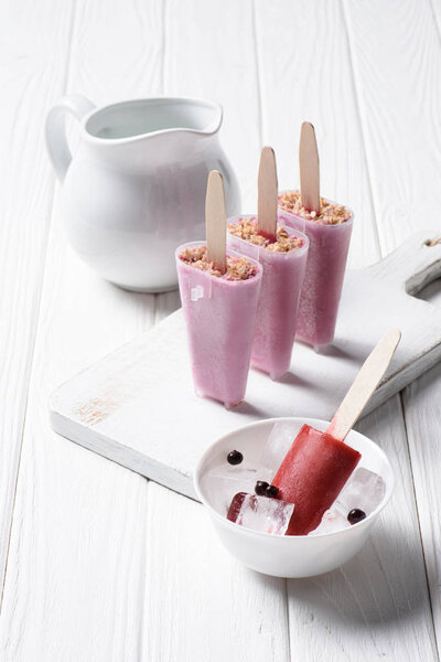 Delicious ice cream in molds on wooden background