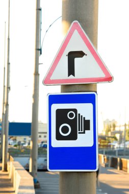 close up view of pole with traffic signal cameras and turn right signs clipart