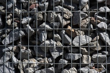 full frame image of metal cage covered stones background clipart