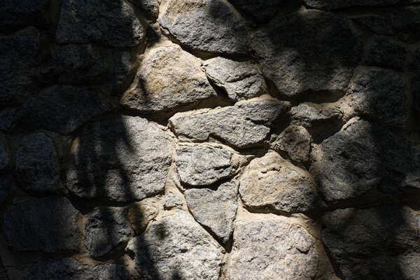 full frame image of stone wall with sunlight background 