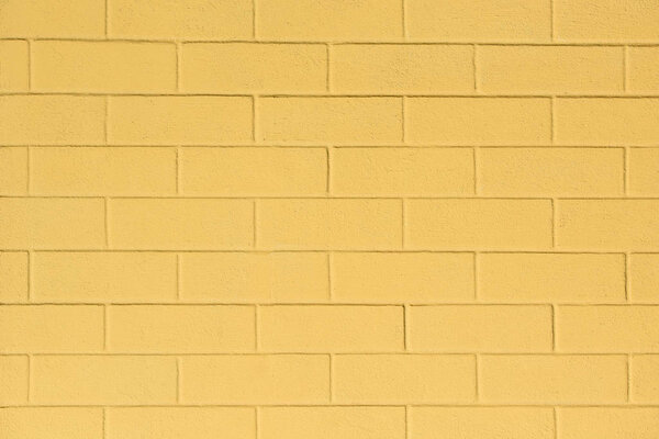 full frame image of painted yellow wall background 