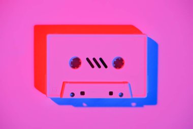 toned pink picture of retro audio cassette on pink surface clipart