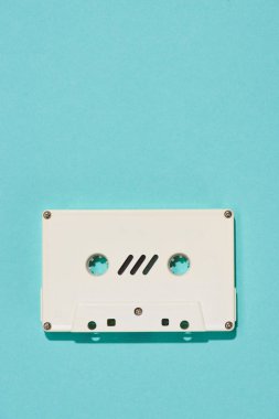 top view of white retro audio cassette isolated on blue clipart