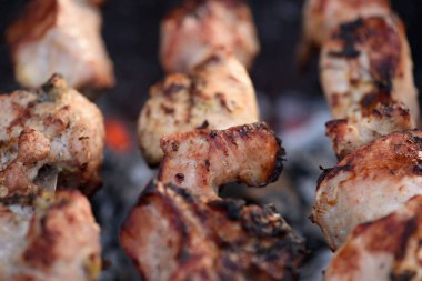 close up of pork kebab (shashlik) on skewers at grill clipart