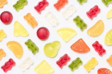 top view of colorful various gummy candies isolated on white clipart