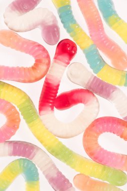 top view of colorful gummy worms isolated on white clipart
