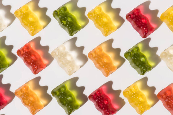 full frame shot of colorful gummy bears pattern on white