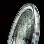 Selective focus of blurred observation wheel at night on black background